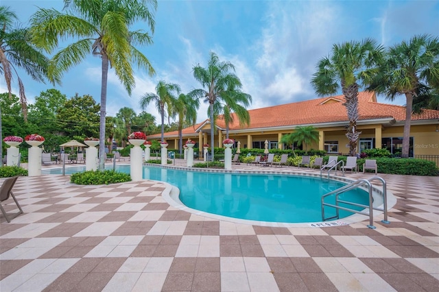 pool with fence and a patio