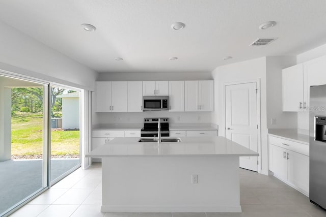 kitchen featuring light countertops, stainless steel appliances, visible vents, and a sink