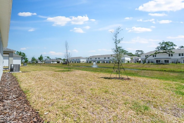 view of yard with a residential view and central AC