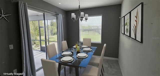 3043 Beaver Creek Dr, Kissimmee, FL 34746 - dining space featuring a wealth of natural light, a chandelier, and baseboards