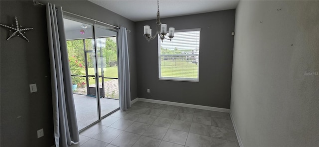 3043 Beaver Creek Dr, Kissimmee, FL 34746 - unfurnished dining area featuring light tile patterned floors, an inviting chandelier, and baseboards