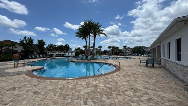 3043 Beaver Creek Dr, Kissimmee, FL 34746 - community pool featuring a patio area