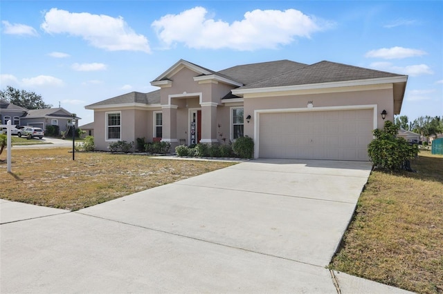 view of front of home with a front yard, stucco siding, a garage, and concrete driveway