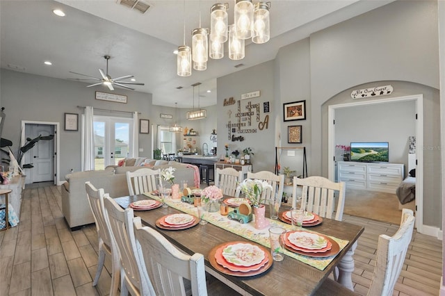 dining area with recessed lighting, ceiling fan with notable chandelier, light wood finished floors, and visible vents
