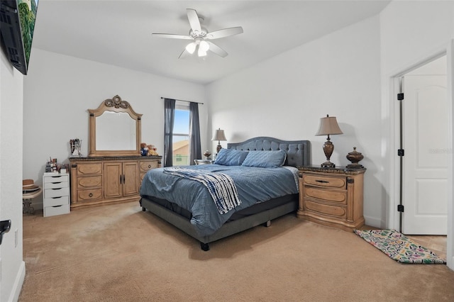 bedroom featuring a ceiling fan and light colored carpet