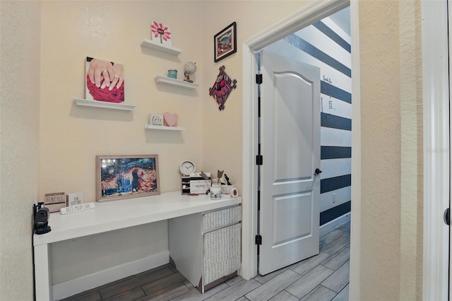 hallway with baseboards and wood tiled floor