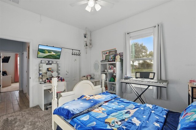 carpeted bedroom with a closet and ceiling fan