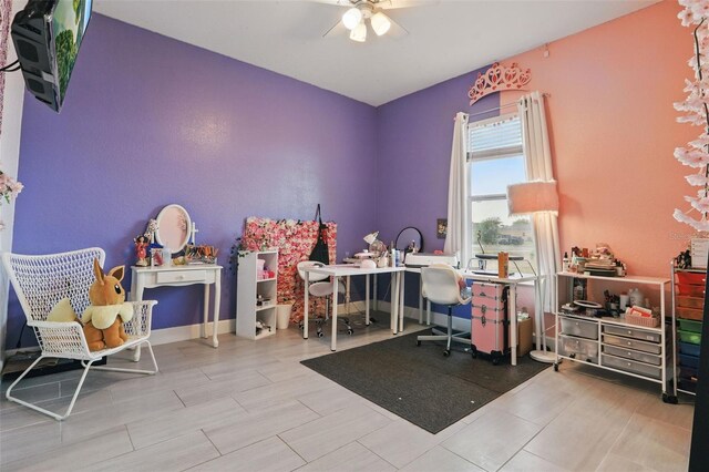 game room featuring baseboards and a ceiling fan