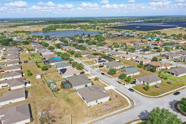 drone / aerial view featuring a residential view and a water view
