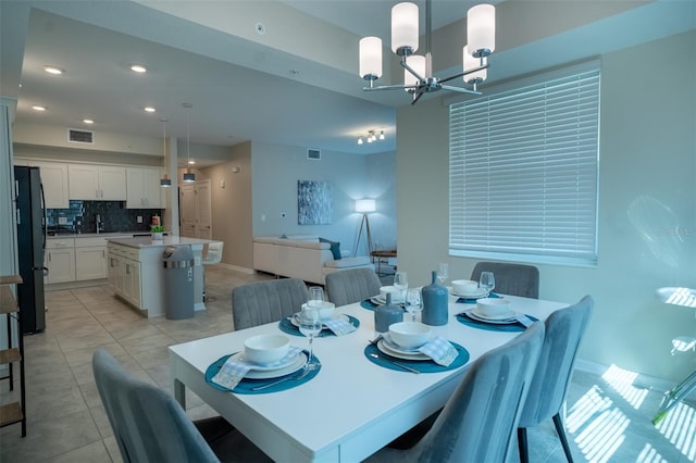 dining area featuring visible vents, recessed lighting, light tile patterned floors, and an inviting chandelier