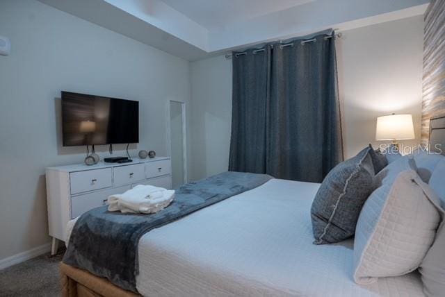 carpeted bedroom with baseboards