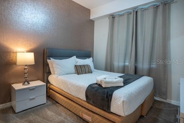 carpeted bedroom with baseboards