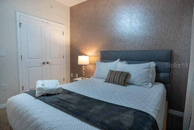 bedroom featuring a closet and baseboards