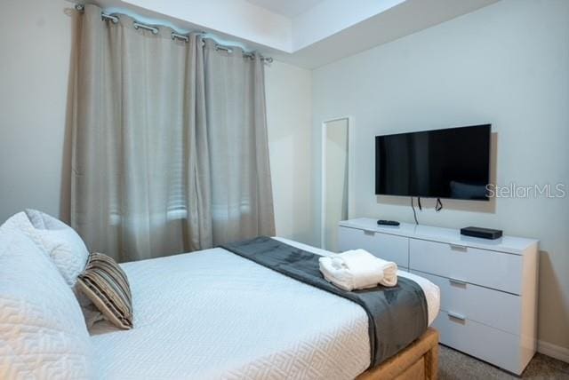 bedroom featuring light carpet