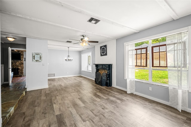 unfurnished living room featuring a fireplace, visible vents, and wood finished floors