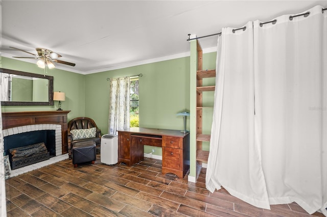 interior space featuring a fireplace, wood tiled floor, a ceiling fan, and crown molding