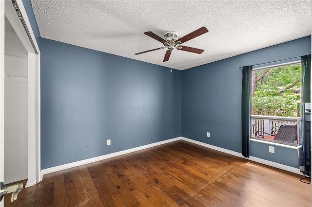 empty room with hardwood / wood-style floors, baseboards, a ceiling fan, and a textured ceiling