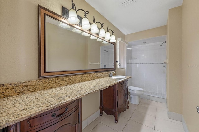 full bathroom with visible vents, a tile shower, toilet, vanity, and tile patterned flooring