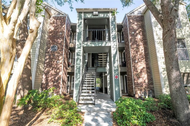 5136 Park Central Dr Unit 212, Orlando, FL 32839 - townhome / multi-family property featuring stairs, brick siding, and a balcony