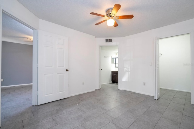 5136 Park Central Dr Unit 212, Orlando, FL 32839 - unfurnished bedroom with ceiling fan, a textured ceiling, visible vents, a closet, and a spacious closet