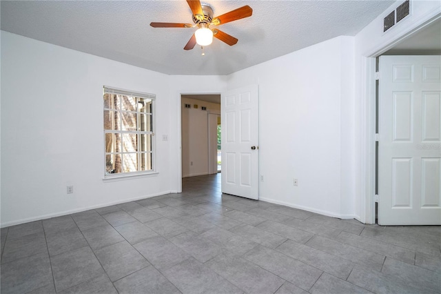 5136 Park Central Dr Unit 212, Orlando, FL 32839 - tiled spare room with baseboards, a ceiling fan, a textured ceiling, and visible vents