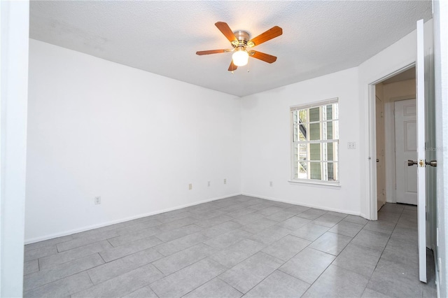 5136 Park Central Dr Unit 212, Orlando, FL 32839 - tiled empty room with a ceiling fan, a textured ceiling, and baseboards