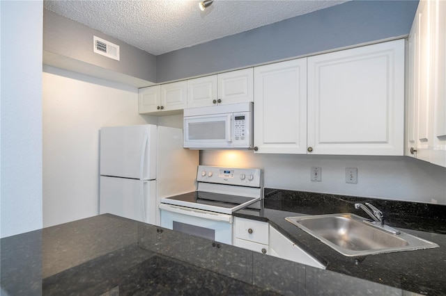5136 Park Central Dr Unit 212, Orlando, FL 32839 - kitchen featuring visible vents, white appliances, white cabinetry, a textured ceiling, and a sink