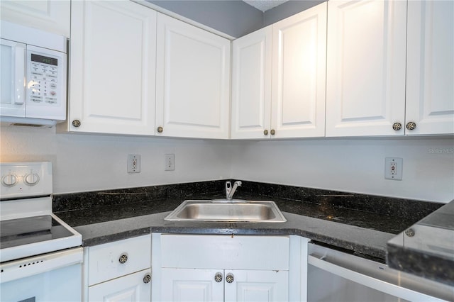 5136 Park Central Dr Unit 212, Orlando, FL 32839 - kitchen with a sink, white cabinetry, dark stone countertops, and white appliances