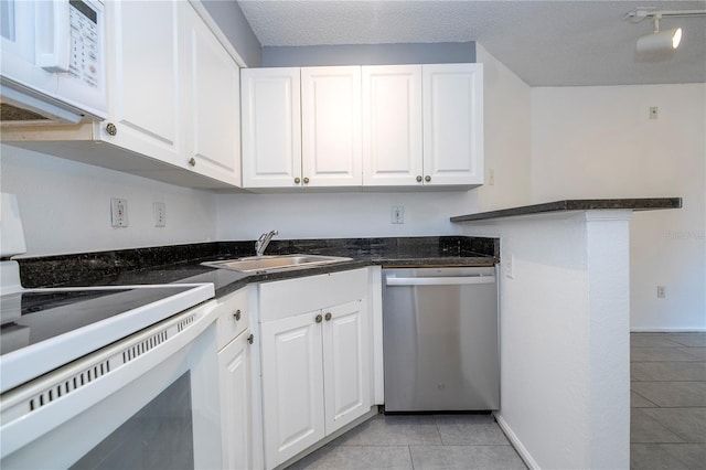 5136 Park Central Dr Unit 212, Orlando, FL 32839 - kitchen with a textured ceiling, a sink, light tile patterned floors, white cabinets, and white appliances