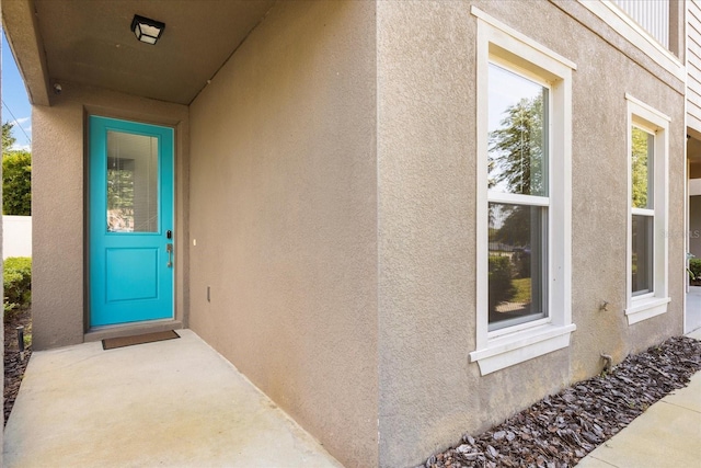 doorway to property with stucco siding