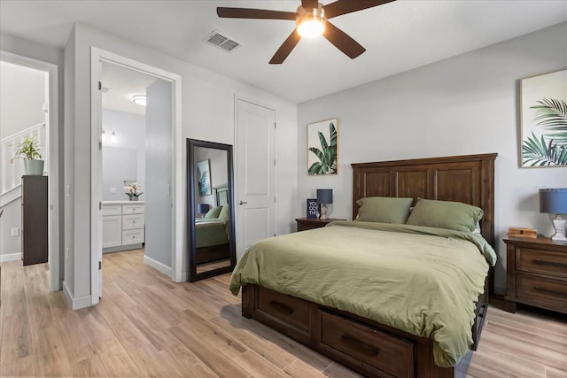 bedroom with light wood-style flooring, ceiling fan, baseboards, ensuite bath, and visible vents