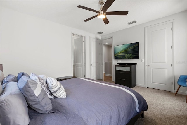 bedroom featuring ceiling fan, baseboards, visible vents, and carpet flooring