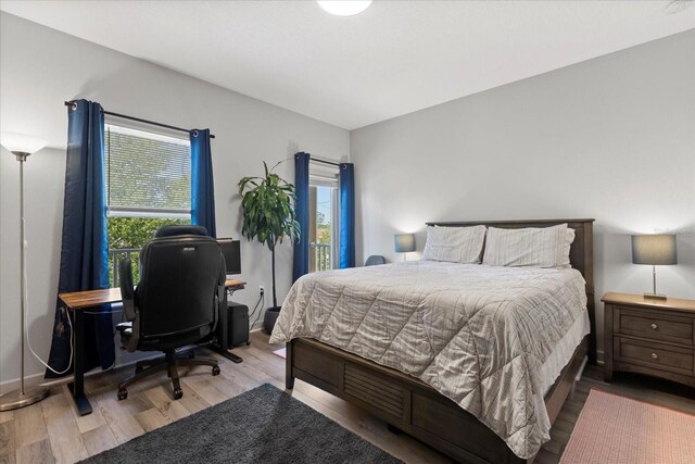 bedroom with baseboards and wood finished floors
