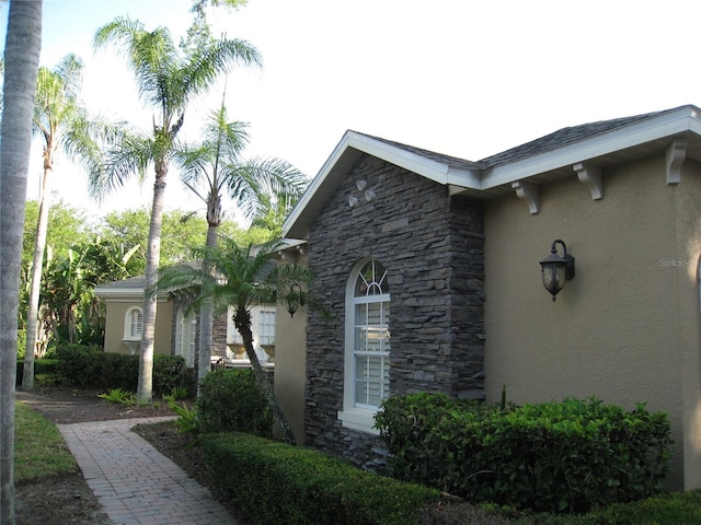 view of home's exterior with stone siding and stucco siding