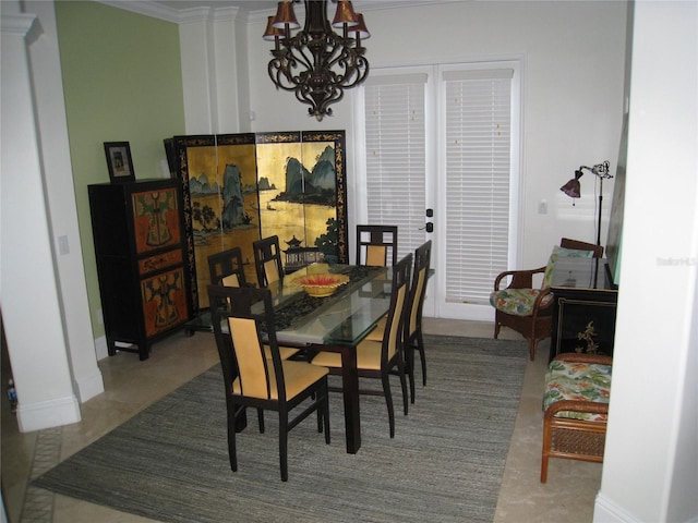 dining area with an inviting chandelier, baseboards, and crown molding