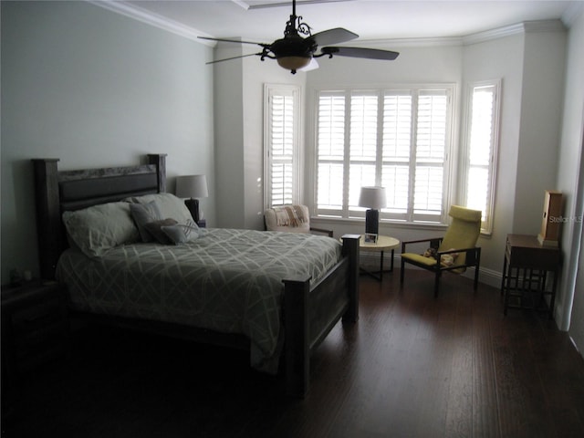 bedroom with crown molding, baseboards, and dark wood-style floors