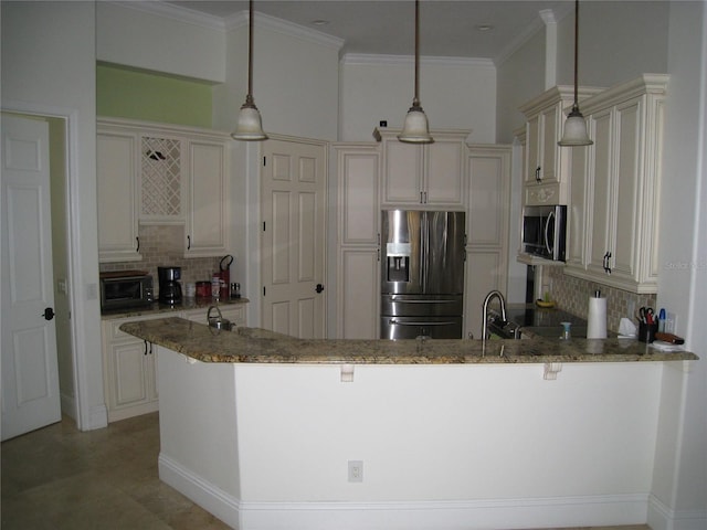 kitchen with stone countertops, a peninsula, tasteful backsplash, a kitchen breakfast bar, and appliances with stainless steel finishes