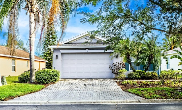 151 Bell Tower Xing W, Kissimmee, FL 34759 - view of front of property with stucco siding, decorative driveway, and a garage