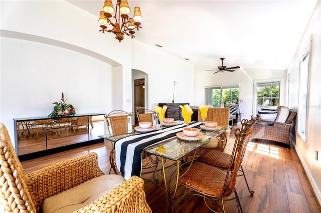 151 Bell Tower Xing W, Kissimmee, FL 34759 - dining room featuring arched walkways, wood-type flooring, a ceiling fan, and a chandelier