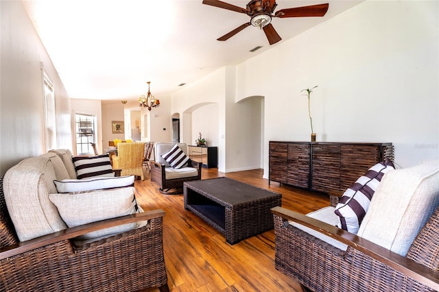 151 Bell Tower Xing W, Kissimmee, FL 34759 - living area with a ceiling fan, arched walkways, wood finished floors, and a chandelier