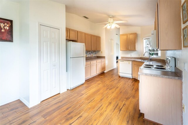 151 Bell Tower Xing W, Kissimmee, FL 34759 - kitchen with white appliances, light wood-style flooring, a sink, a ceiling fan, and backsplash