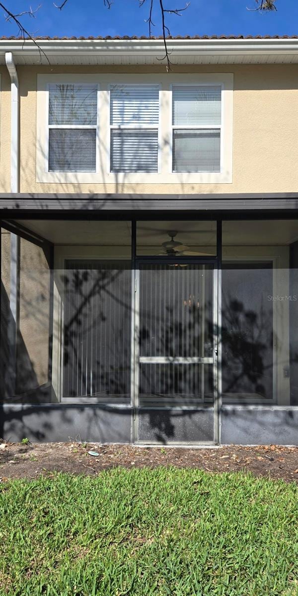 exterior space with stucco siding and a sunroom