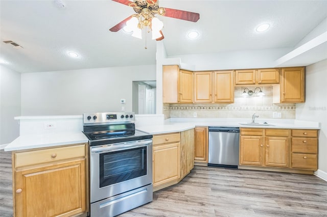 kitchen with visible vents, light countertops, a ceiling fan, stainless steel appliances, and light wood-style flooring