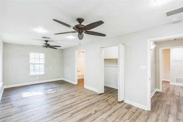 unfurnished bedroom featuring visible vents, baseboards, and wood finished floors