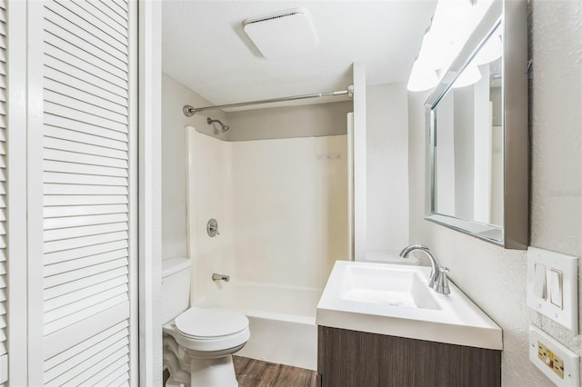 full bath with toilet, bathtub / shower combination, vanity, and wood finished floors