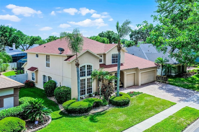 3033 Zaharias Dr, Orlando, FL 32837 - view of front facade with driveway, stucco siding, an attached garage, and a front lawn