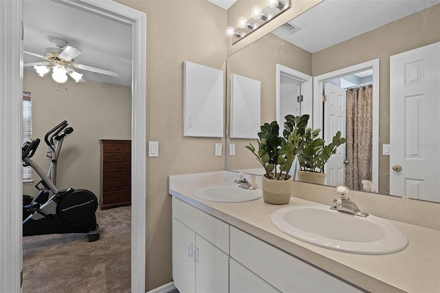 3033 Zaharias Dr, Orlando, FL 32837 - full bathroom featuring a sink, ceiling fan, double vanity, and a textured ceiling