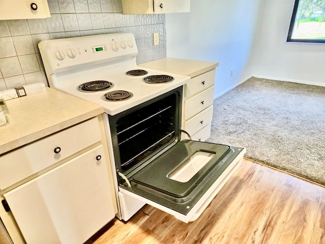 5 Buck Cir # B5, Haines City, FL 33844 - kitchen featuring light countertops, white range with electric stovetop, and white cabinetry