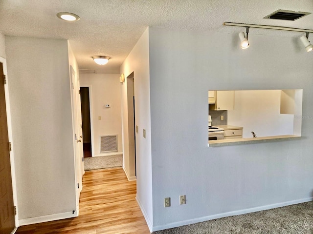 5 Buck Cir # B5, Haines City, FL 33844 - corridor with a textured ceiling, visible vents, baseboards, and light wood-type flooring