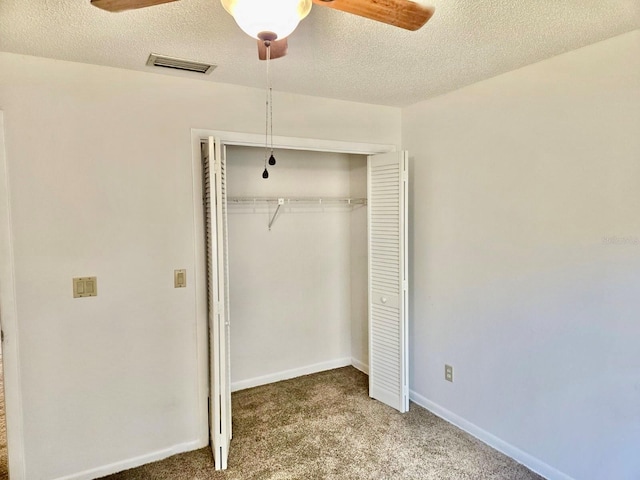 5 Buck Cir # B5, Haines City, FL 33844 - unfurnished bedroom featuring a ceiling fan, a closet, a textured ceiling, carpet, and visible vents